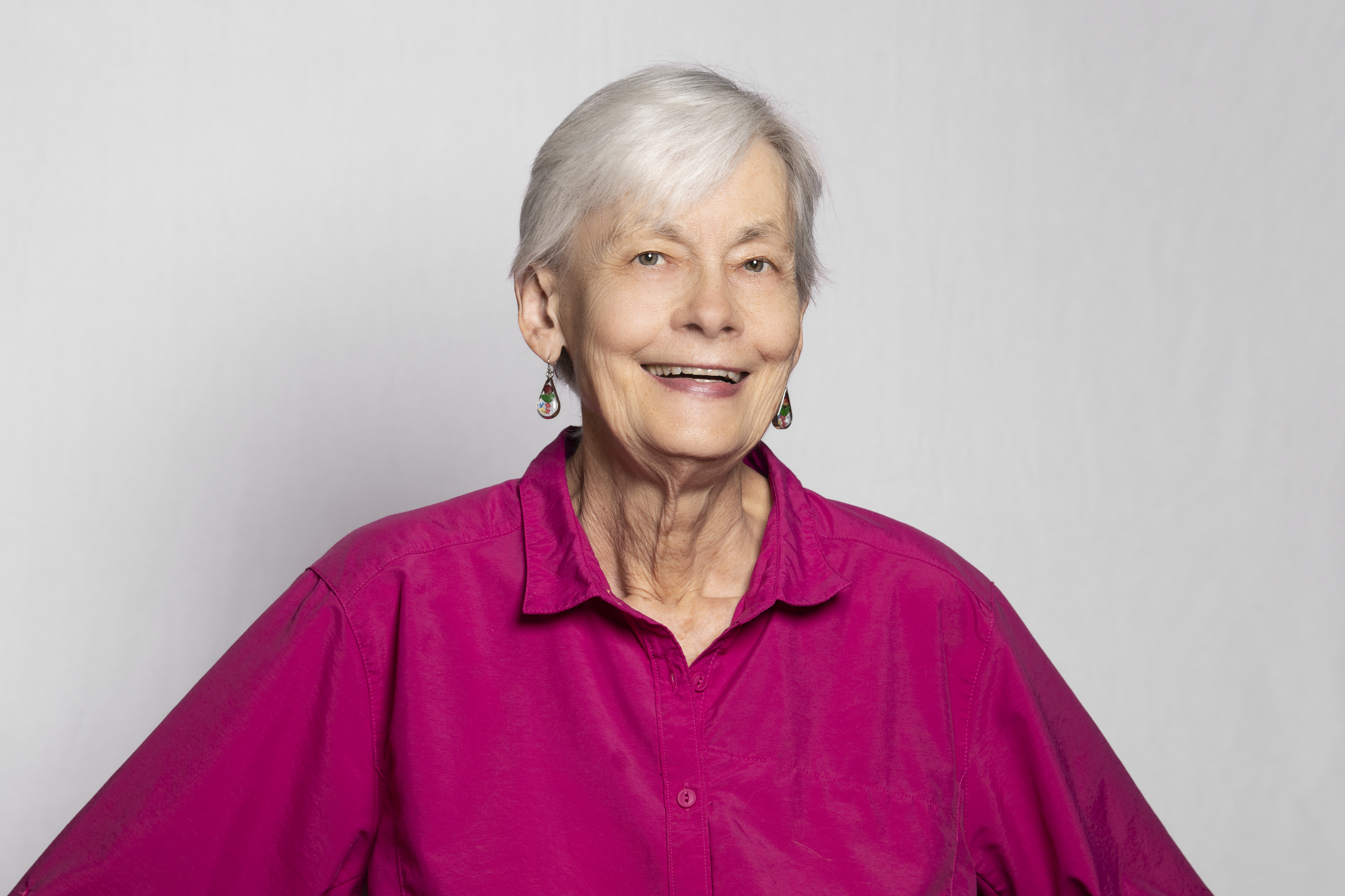 Carol B. Schwalbe, executive director for ODD Foundation, in a lavender blouse in front of a white backdrop.